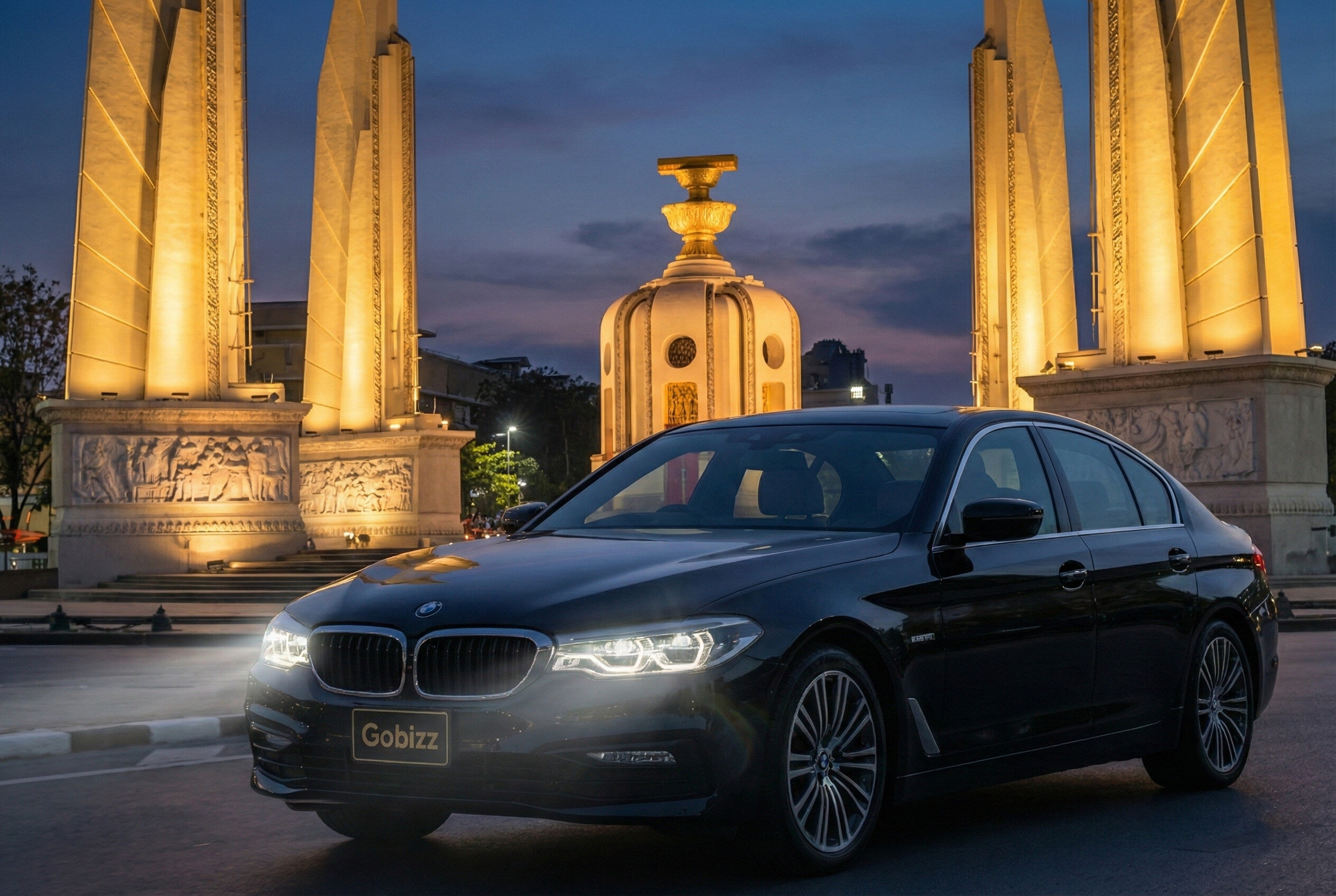 Bangkok Car Rental - BMW 530e, night scene at the monument